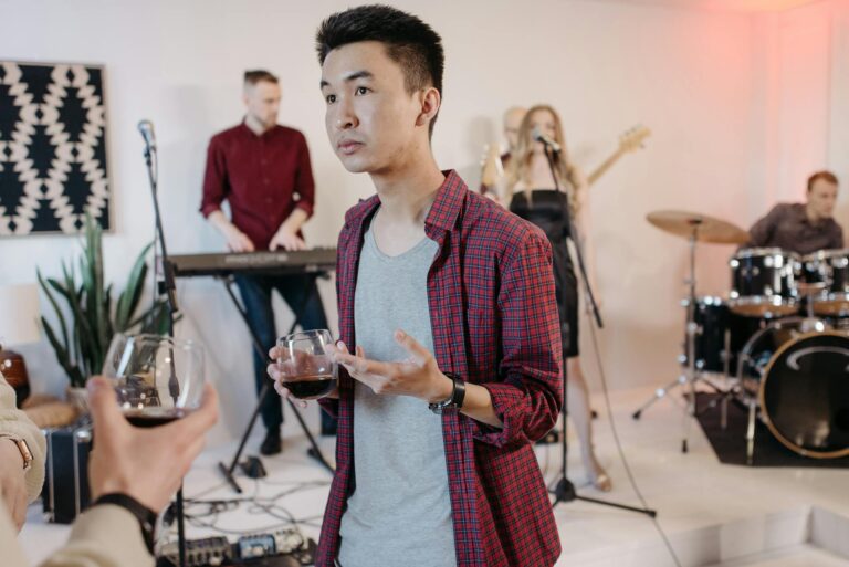 A casual band performance indoors with musicians playing instruments and audience interaction.