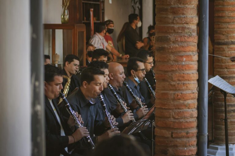 A group of musicians playing clarinets during an indoor performance in Venezuela.